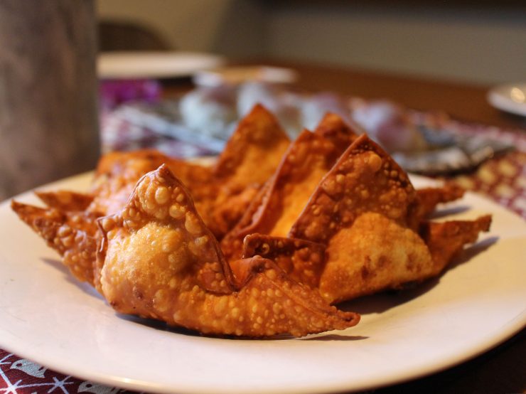 Deep fried crab wontons on a plate.
